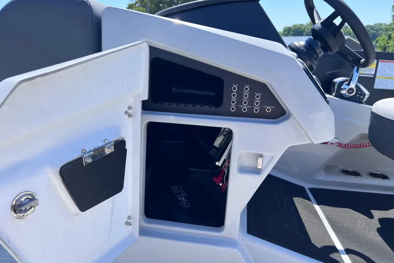 Slide: The Image of Open storage compartment in 2026 Alera M23L boat dashboard. - 11