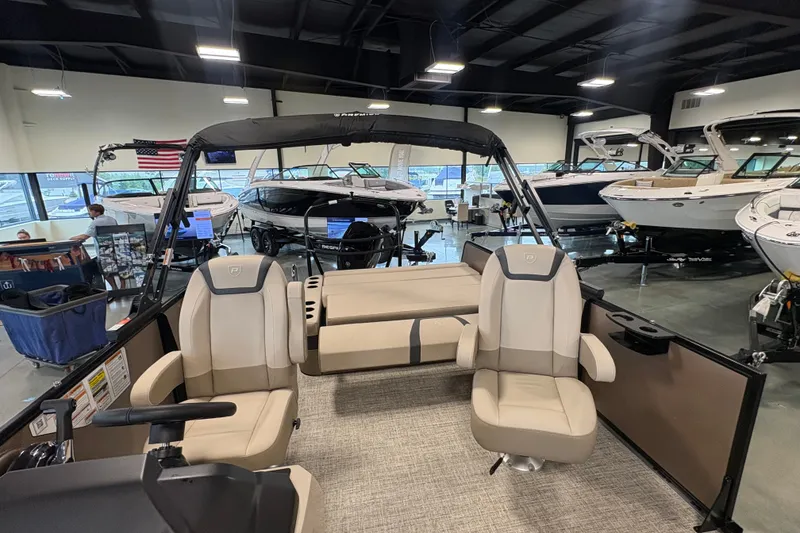 Slide: The Image of 2027 Premier 220 Sunscape RL - CL boat interior with seating, displayed in showroom. - 9