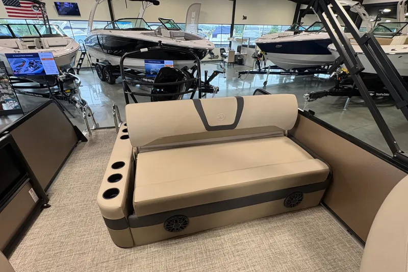 Slide: The Image of 2027 Premier 220 Sunscape RL - CL boat interior with beige seating and cup holders. - 11