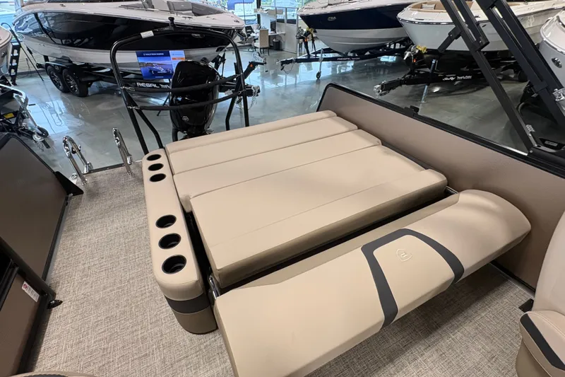 Slide: The Image of Premier 220 Sunscape RL - CL 2027 boat interior with beige seating and cup holders. - 10