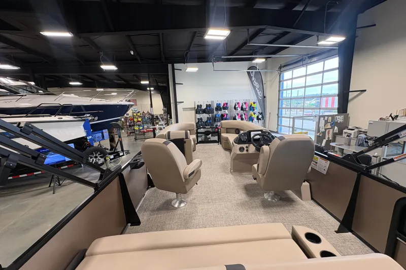 Slide: The Image of 2027 Premier 220 Sunscape RL - CL boat interior in showroom with seating and control panel. - 2