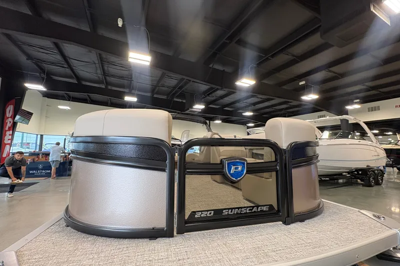 Slide: The Image of 2027 Premier 220 Sunscape RL-CL pontoon boat displayed indoors. - 14