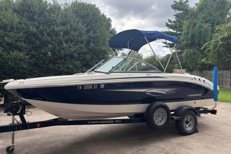 The Image of 2012 Chaparral 19 H2O Ski & Fish boat on trailer, parked outdoors. - 0