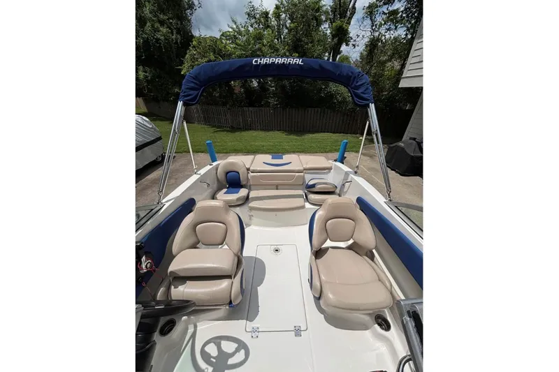 Slide: The Image of 2012 Chaparral 19 H2O Ski & Fish boat interior with beige seating and blue accents. - 1