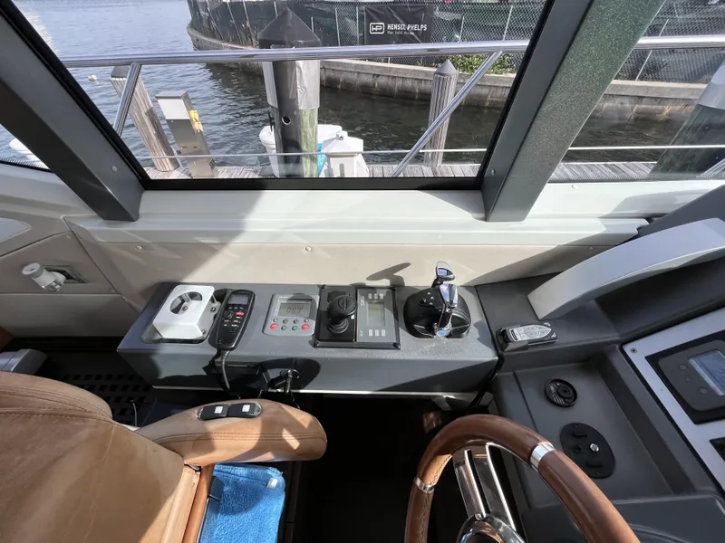 Slide: The Image of Control panel of a 2008 Azimut 62S yacht, featuring navigation and steering equipment. - 15