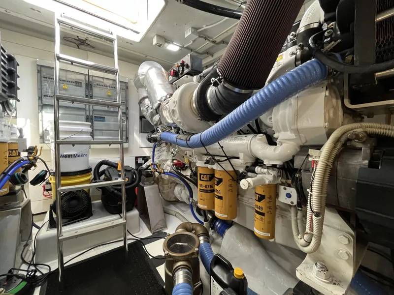 Slide: The Image of Engine room of a 2008 Azimut 62S yacht, featuring mechanical components and a ladder. - 42