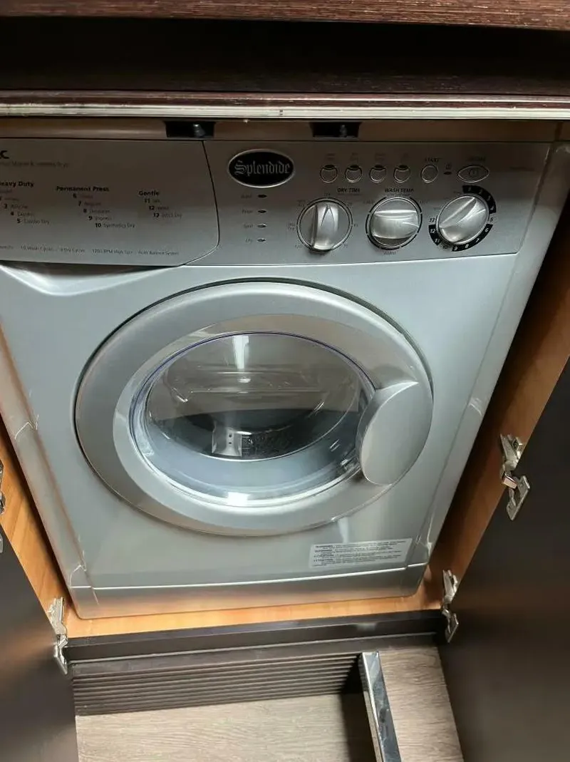 Slide: The Image of Washing machine inside 2008 Azimut 62S yacht, featuring control knobs and front-loading door. - 46