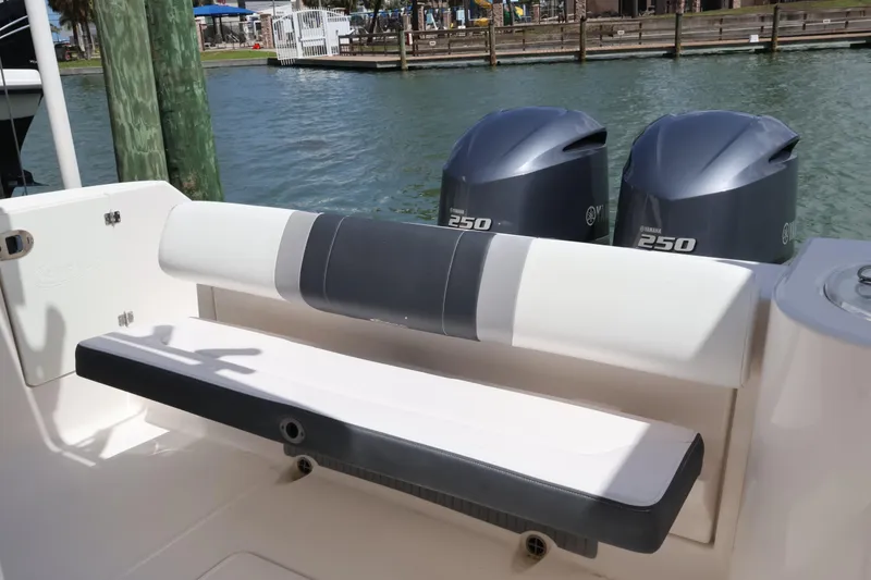 Slide: The Image of 2020 Robalo R272 Center Console boat with Yamaha 250 engines, docked by the water. - 12