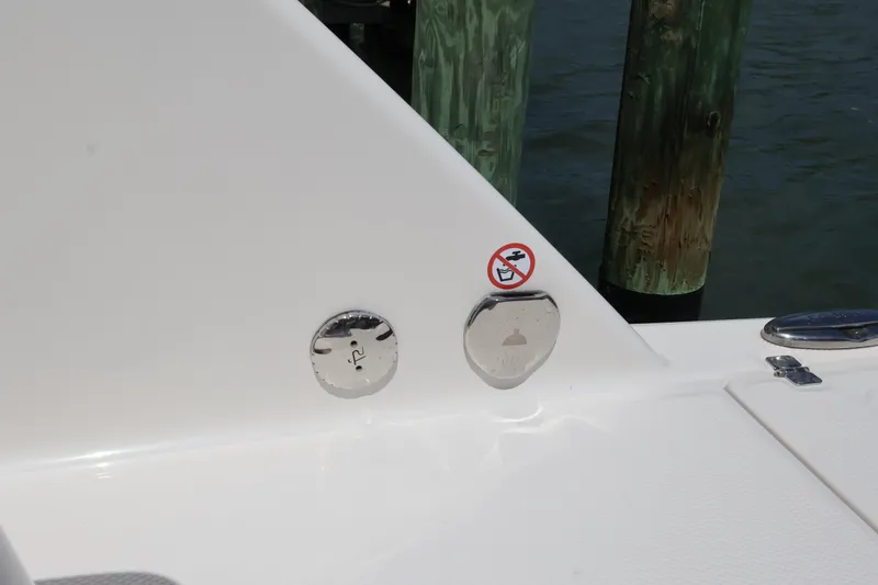 Slide: The Image of 2020 Robalo R272 Center Console boat detail with dock in background. - 16