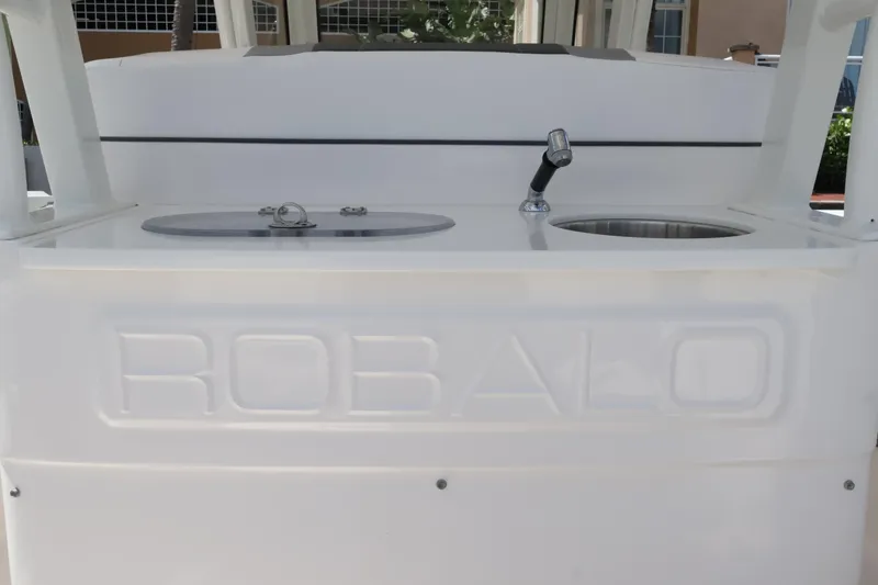 Slide: The Image of 2020 Robalo R272 Center Console boat with sink and storage compartment. - 17