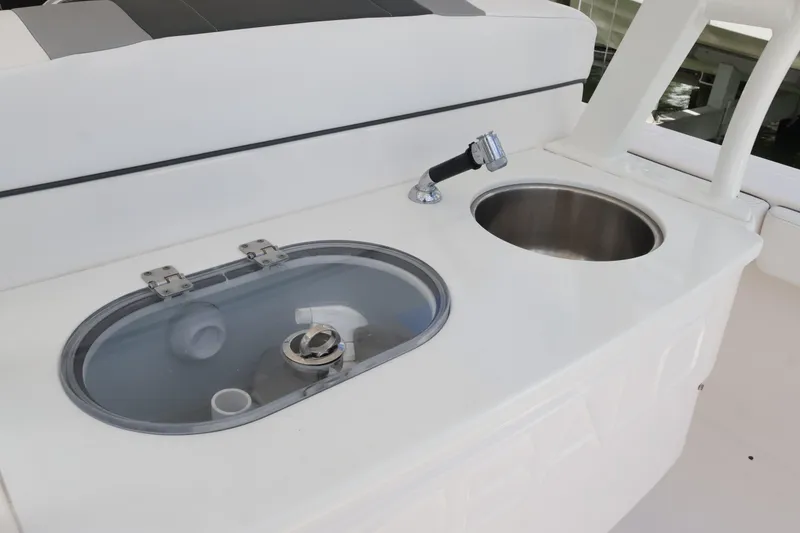 Slide: The Image of 2020 Robalo R272 Center Console boat sink and storage compartment. - 20