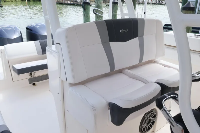 Slide: The Image of 2020 Robalo R272 Center Console boat interior with cushioned seating and dual engines. - 22