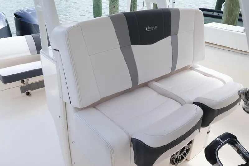 Slide: The Image of 2020 Robalo R272 Center Console boat seating with white and gray upholstery. - 23