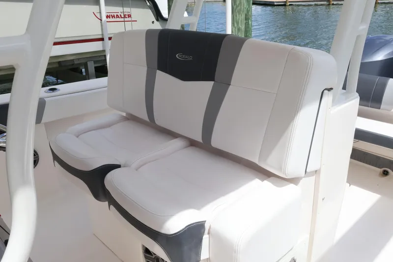 Slide: The Image of 2020 Robalo R272 Center Console boat seating, featuring white and gray cushioned seats. - 24