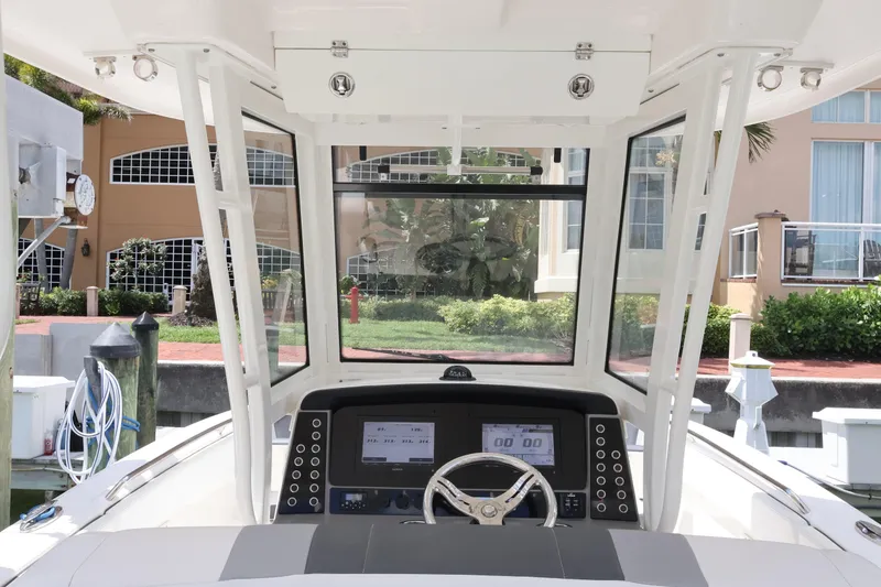 Slide: The Image of 2020 Robalo R272 Center Console boat helm with modern dashboard and steering wheel. - 25