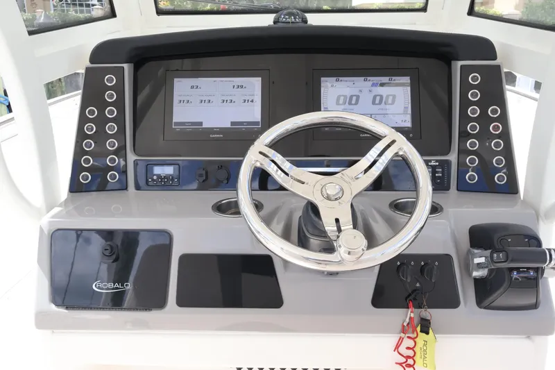 Slide: The Image of 2020 Robalo R272 Center Console helm with dual displays and modern controls. - 26