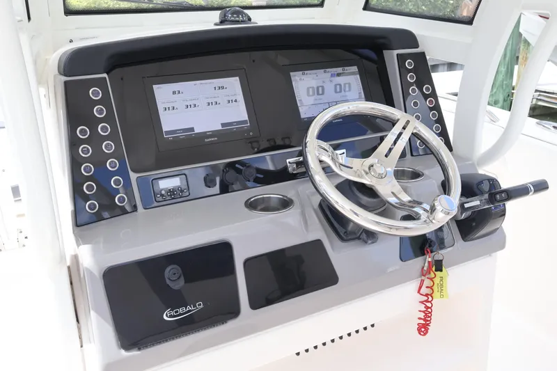 Slide: The Image of 2020 Robalo R272 Center Console dashboard with steering wheel and digital displays. - 27