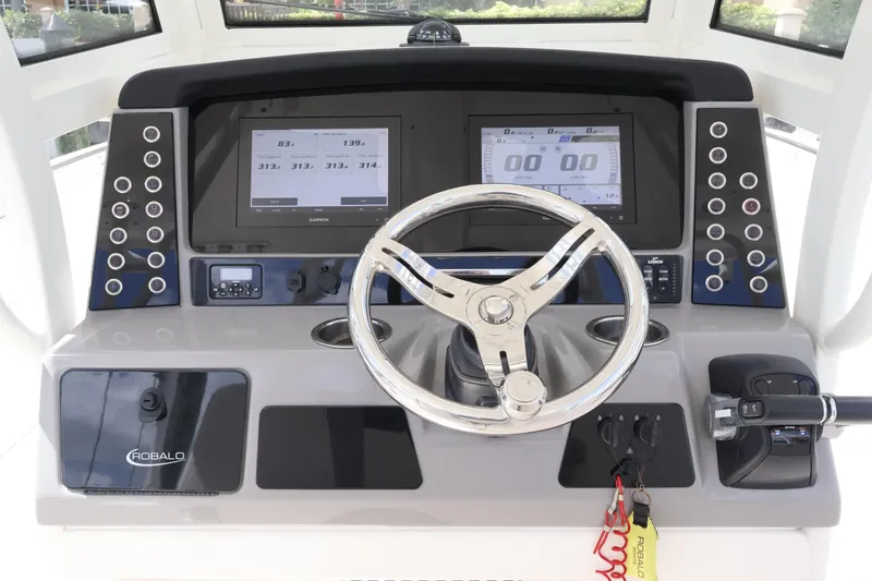 Slide: The Image of 2020 Robalo R272 Center Console dashboard with steering wheel and digital displays. - 28