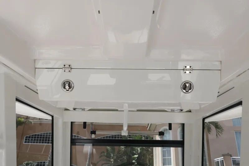 Slide: The Image of 2020 Robalo R272 Center Console boat interior storage compartment with secure latches. - 29
