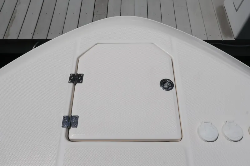 Slide: The Image of 2020 Robalo R272 Center Console boat deck with storage hatch and fittings. - 37