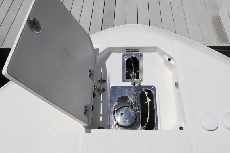 Slide: The Image of 2020 Robalo R272 Center Console anchor locker with open hatch on deck. - 38