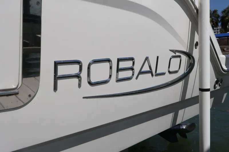 Slide: The Image of 2020 Robalo R272 Center Console boat logo on white hull. - 8