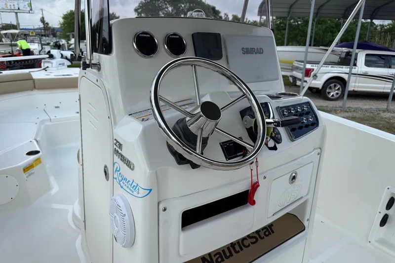 Slide: The Image of 2020 NauticStar 231 Hybrid boat console with steering wheel and controls. - 14