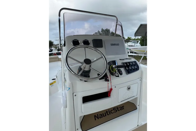 Slide: The Image of 2020 NauticStar 231 Hybrid boat console with steering wheel and navigation controls. - 15