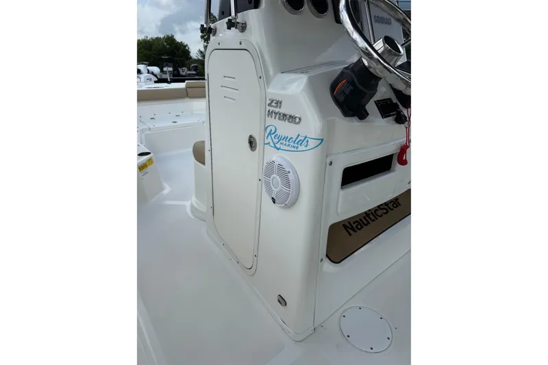Slide: The Image of 2020 NauticStar 231 Hybrid boat interior with steering wheel and control panel. - 16