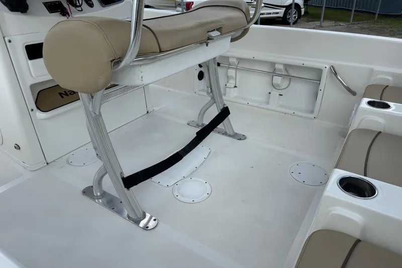 Slide: The Image of 2020 NauticStar 231 Hybrid boat interior with seating and console details. - 17