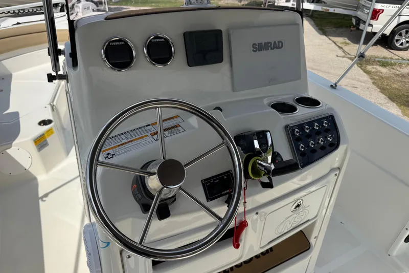 Slide: The Image of 2020 NauticStar 231 Hybrid boat dashboard with steering wheel and controls. - 19
