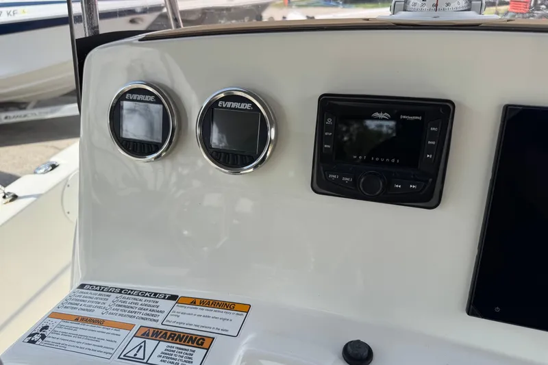 Slide: The Image of Control panel of 2020 NauticStar 231 Hybrid boat with Evinrude gauges and Wet Sounds system. - 23
