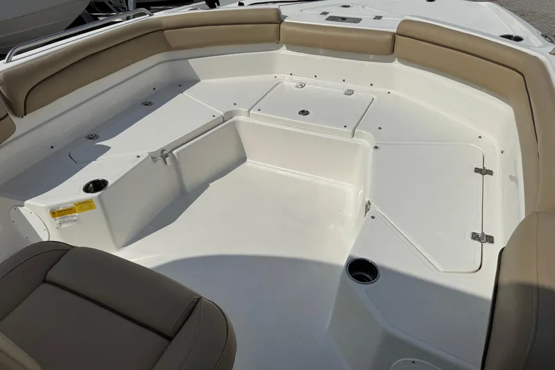 Slide: The Image of 2020 NauticStar 231 Hybrid boat interior with tan seating and storage compartments. - 24