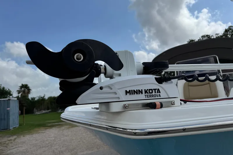 Slide: The Image of 2020 NauticStar 231 Hybrid boat with Minn Kota Terrova motor, under a partly cloudy sky. - 4
