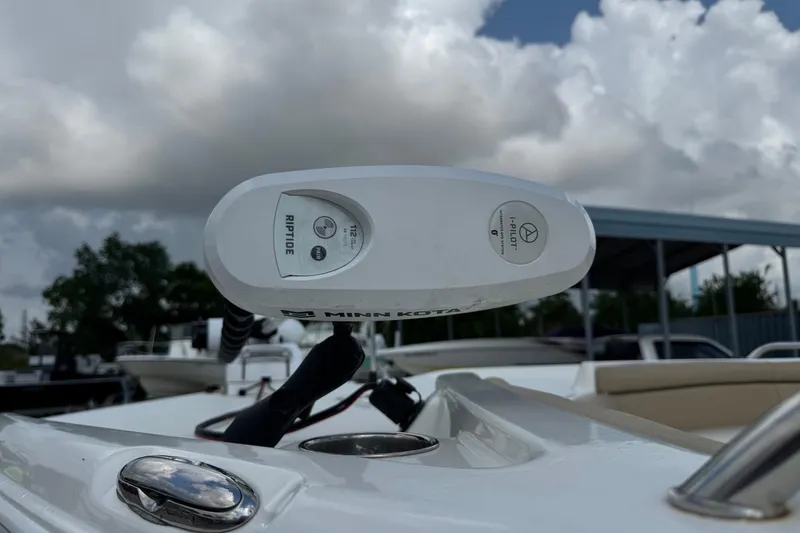 Slide: The Image of Minn Kota Riptide motor on 2020 NauticStar 231 Hybrid boat under cloudy sky. - 5