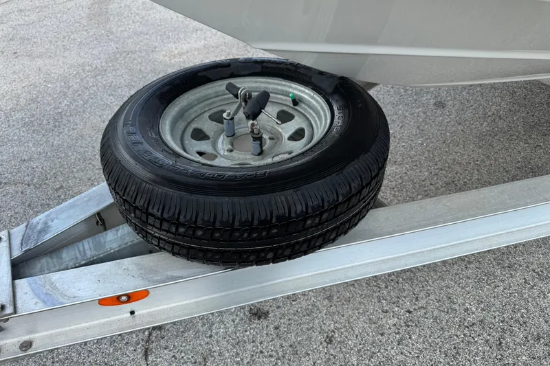 Slide: The Image of Spare tire on a trailer for a 2020 NauticStar 231 Hybrid boat. - 6