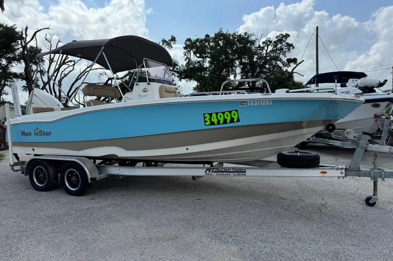 Slide: The Image of 2020 NauticStar 231 Hybrid boat on trailer, blue and white, priced at $34,999. - 8