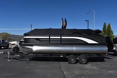 The Image of 2026 Lowe SF 232 Sport Fish pontoon boat on trailer, parked outdoors. - 0