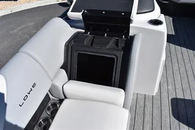 Slide: The Image of 2026 Lowe SF 232 Sport Fish boat interior with white seating and storage compartment. - 16