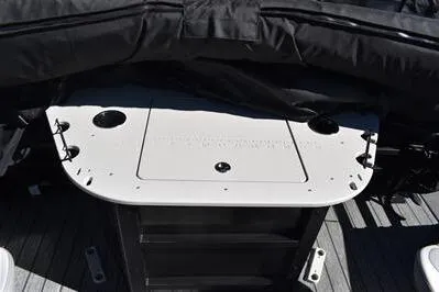 Slide: The Image of 2026 Lowe SF 232 Sport Fish boat interior with fishing rod holders and storage compartment. - 25