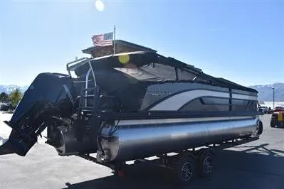 Slide: The Image of 2026 Lowe SF 232 Sport Fish pontoon boat on trailer, under clear blue sky. - 3