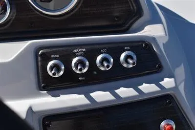 Slide: The Image of Control panel of 2026 Lowe SF 232 Sport Fish boat with switches for bilge, aerator, and accessories. - 31