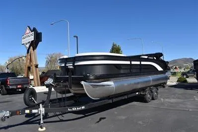 Slide: The Image of 2026 Lowe SF 232 Sport Fish pontoon boat on trailer in parking lot. - 6