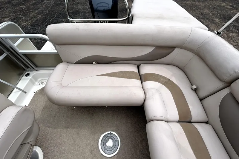 Slide: The Image of 2014 Hurricane FunDeck 226F boat interior with beige and brown cushioned seating. - 10