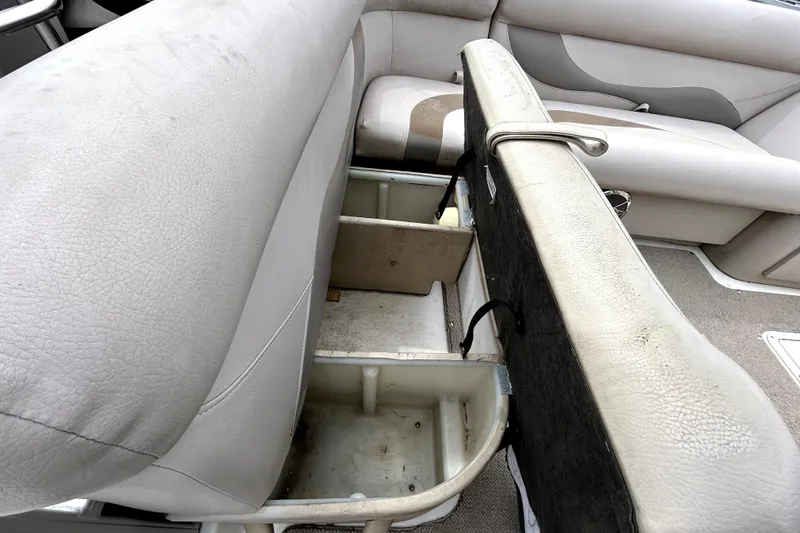 Slide: The Image of 2014 Hurricane FunDeck 226F boat interior with open storage compartments. - 11