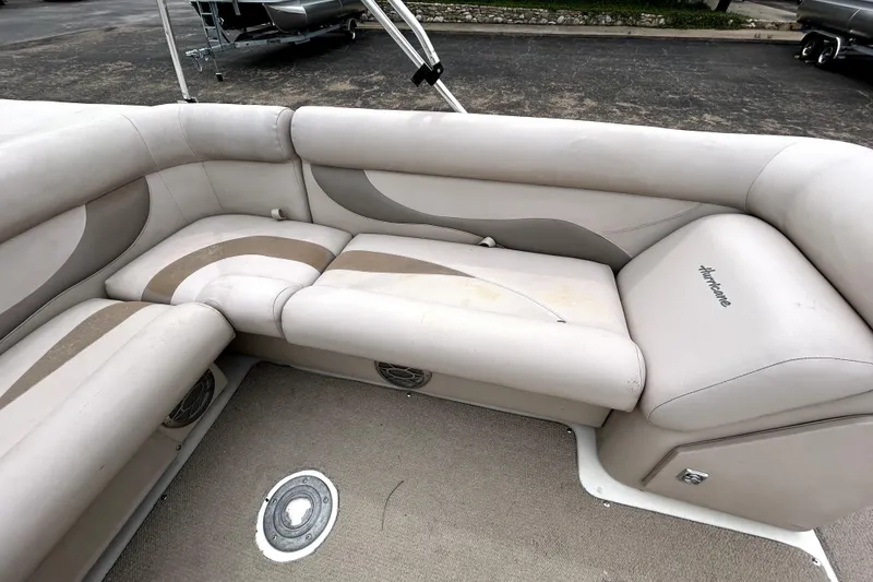 Slide: The Image of 2014 Hurricane FunDeck 226F boat interior with beige seating and carpeted floor. - 12
