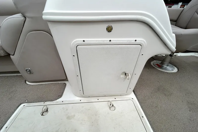Slide: The Image of 2014 Hurricane FunDeck 226F interior storage compartment with beige seating and carpeted flooring. - 14