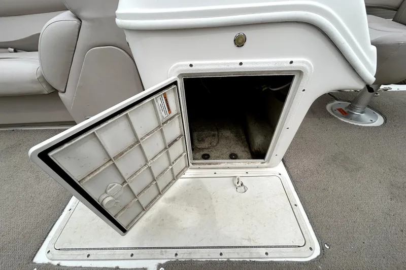 Slide: The Image of Open storage compartment on 2014 Hurricane FunDeck 226F boat, showing interior space. - 15