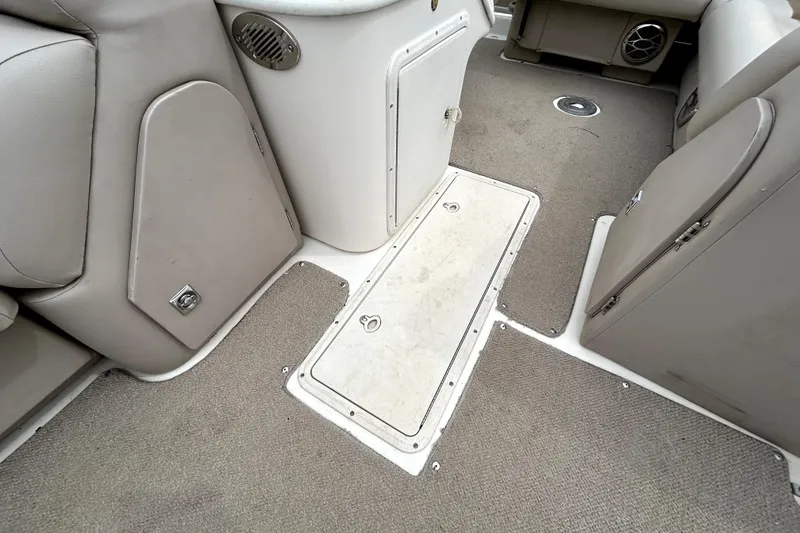 Slide: The Image of Interior of 2014 Hurricane FunDeck 226F boat, featuring carpeted flooring and storage compartments. - 18