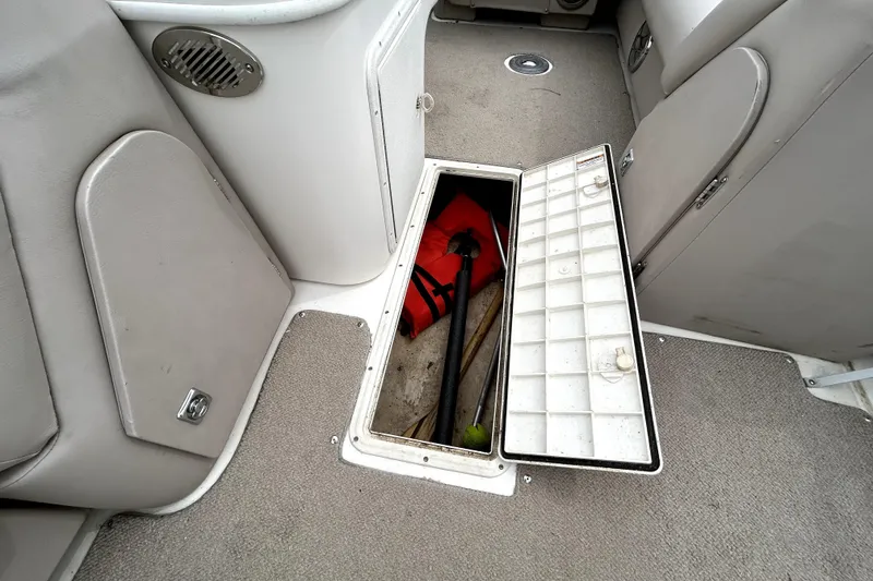 Slide: The Image of 2014 Hurricane FunDeck 226F boat interior with open storage compartment. - 19